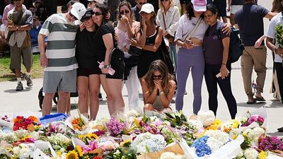 Hundreds gather to lay flowers at the site of the deadly Bondi Beach shooting