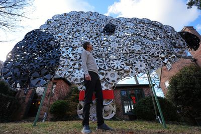 Baltimore cyclist finds joy in collecting lost hubcaps and stringing them into art