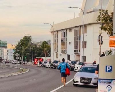 As beachgoers fled the Bondi terror attack, viral photo shows lifeguard sprinting ‘pedal to the metal’ towards the scene