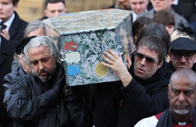 Liam Gallagher carries Mani's coffin at funeral
