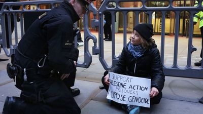Greta Thunberg hauled to London police cell for sitting silently on floor with sign