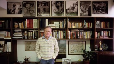 Cluttered, but Curated: Kirk Douglas' Eclectic Combination of Vertical Storage and Gallery Wall from the '80s is Still an Inspiration