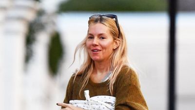 Sienna Miller's barrel leg jeans, cosy jumper and Birkenstock clogs make up the ultimate winter uniform