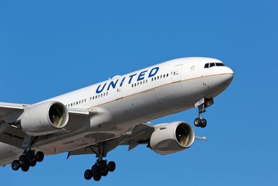 Passenger accused of assaulting United Airlines crew after shadow boxing in the aisle allegedly told fellow travellers: ‘This is a simulation’