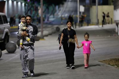 Photos show residents evacuating after explosions in Caracas, Venezuela