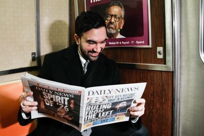 French tourists didn’t believe the young guy on the subway was New York City’s new mayor, so he held up the newspaper to prove it