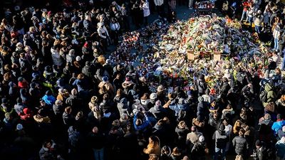 Hundreds march in silence to honour Swiss Alps bar fire victims