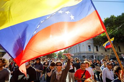 Woman wearing ‘globalise the intifada’ jacket among three arrested at Sydney protest against US action in Venezuela