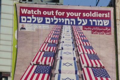 Banner showing US and Israel coffins lining ground displayed in Iran after Trump’s threat