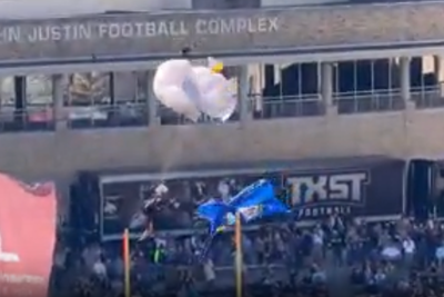 Skydiver makes a hard landing after getting caught in net while parachuting into college football Armed Forces Bowl