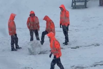 Amsterdam Schiphol staff play in snow as wintry weather causes travel chaos