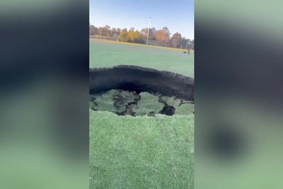 Public urged to stay away as 26ft sinkhole opens up on sports field