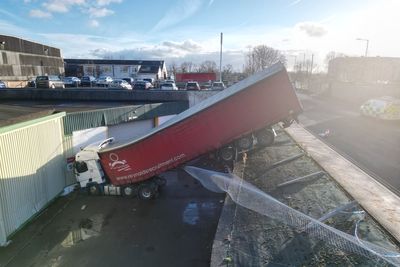 Lorry becomes wedged after crashing down steep bank