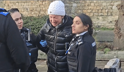 Shocking moment woman is handcuffed and fined £100 for feeding pigeons in London