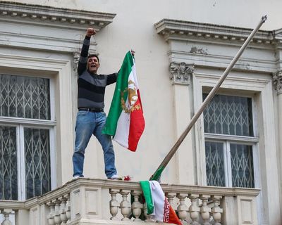 Protester pulls down national flag from Iranian embassy in London