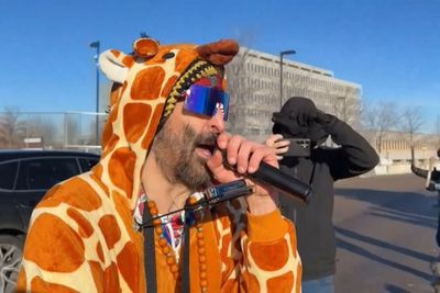 ICE agents force protester in giraffe costume to ground at tense Minneapolis demonstration