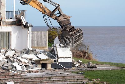 Fourth clifftop home at risk of falling into the sea demolished