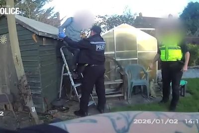 Wanted man gets stuck on garden shed roof while fleeing police
