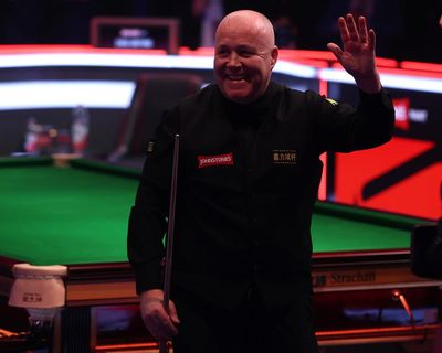 John Higgins rides wild fluke to win final three frames and reach Masters semi