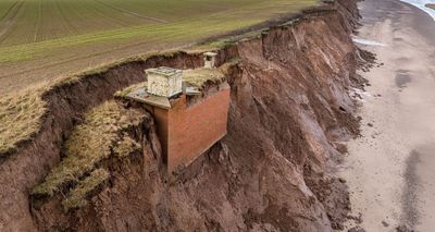Cold War nuclear bunker just ‘days away’ from falling into sea as it teeters on the edge of a cliff