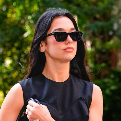 Dua Lipa Parties in a $586 Little Black Mini Dress, Leather Boots, and a Golden Crown