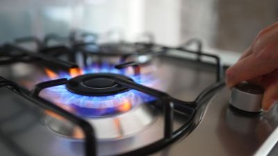Here’s why your gas stove flames turn orange, and whether it’s safe to keep cooking