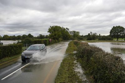Three people rescued from vehicles as heavy rain causes floods