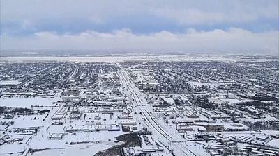 Drone footage shows snow-covered US cities, snow plows at work