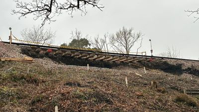 Dramatic image shows how landslide leaves rail line in London commuter belt hanging in mid-air
