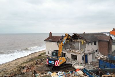 Demolition of six more homes begins in erosion-hit seaside village