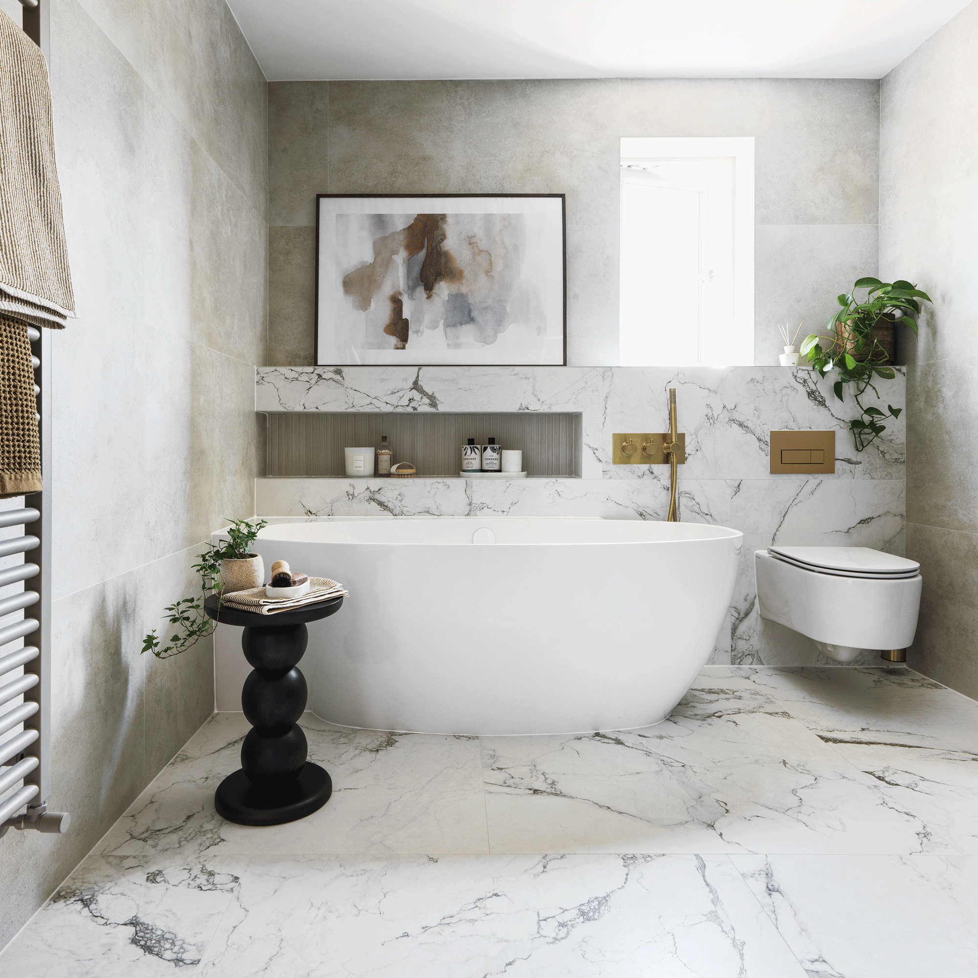 Defined by contemporary calm, this en suite is full of elegant modern touches and warm brass accents