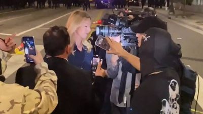 Watch: Anti-ICE protesters surround female reporter, attempt to cut camera cable during LA Protest