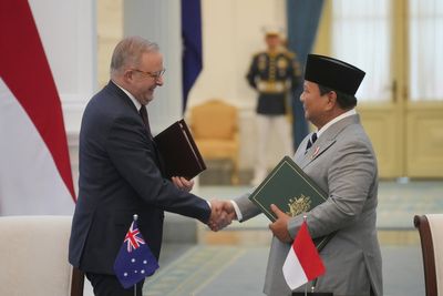 Leaders of Indonesia and Australia sign a new security treaty to affirm deeper ties