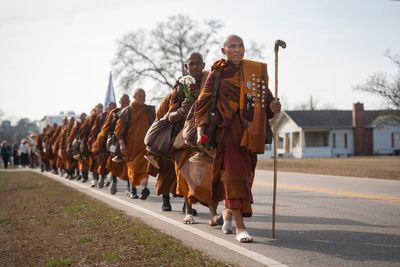 Photos of monks and rescue dog as they finish cross-country peace walk in Washington, DC