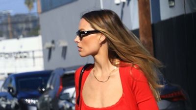 Everyone will know you're a fashion person if you wear your blue jeans with striking red knitwear like Margot Robbie