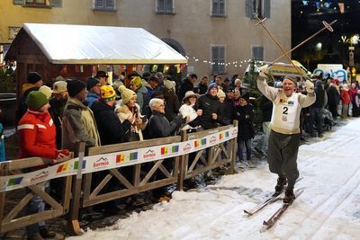Locals ski through Bormio streets in a traditional cross-country race, in photos
