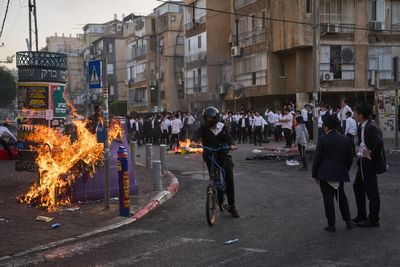 Two female Israeli soldiers rescued after they are chased by huge crowd of ultra-Orthodox men during riot