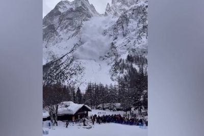 Moment avalanche rushes down Alps mountain as skiers watch on