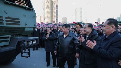 North Korean leader Kim Jong Un drives rocket launcher vehicle