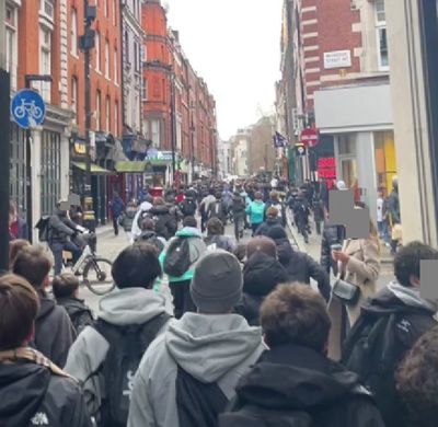 Hundreds of teenagers swarm central London throwing boxes at police for pop-up shop