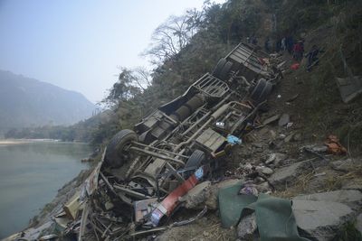 A packed bus plunges off a Nepal highway, killing 19 and injuring 25