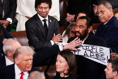 Democratic Rep. Al Green holds ‘Black People Aren’t Apes’ sign as he is booted from Trump’s State of the Union