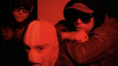 "Ya think it’s all poetry and clovers, when it’s raincoats and police Land Rovers. Salt of the earth, looking over their shoulder." Kneecap share moody and intense new single Smugglers & Scholars