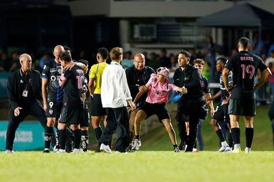 Worrying World Cup sign? Pitch invader hauls Lionel Messi to the ground at Inter Miami ground after evading clutches of security