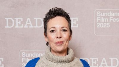 Olivia Colman shows us the best way to style baggy barrel leg jeans, adding a chunky Argyle knit and suede trainers