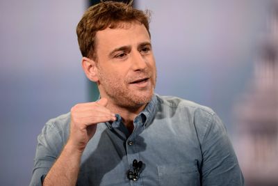 Slack cofounder says workers and CEOs can get stuck doing 'fake' work like pre-meetings and slide shows
