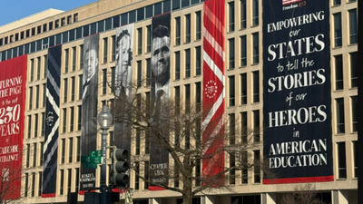 Charlie Kirk's Banner Displayed at Education Department: Critics Say He Left College and Called It a 'Liberal Scam'