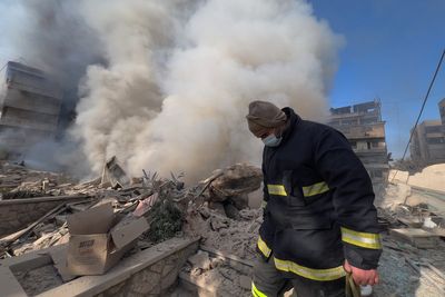 Photos show Lebanese people fleeing and buildings wrecked after Israeli strikes