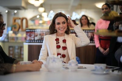 Spice girl: Kate proves partial to a chilli chutney as she meets restaurant team