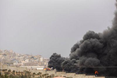 Tehran engulfed in thick black smoke after heavy wave of US-Israeli strikes on oil depots